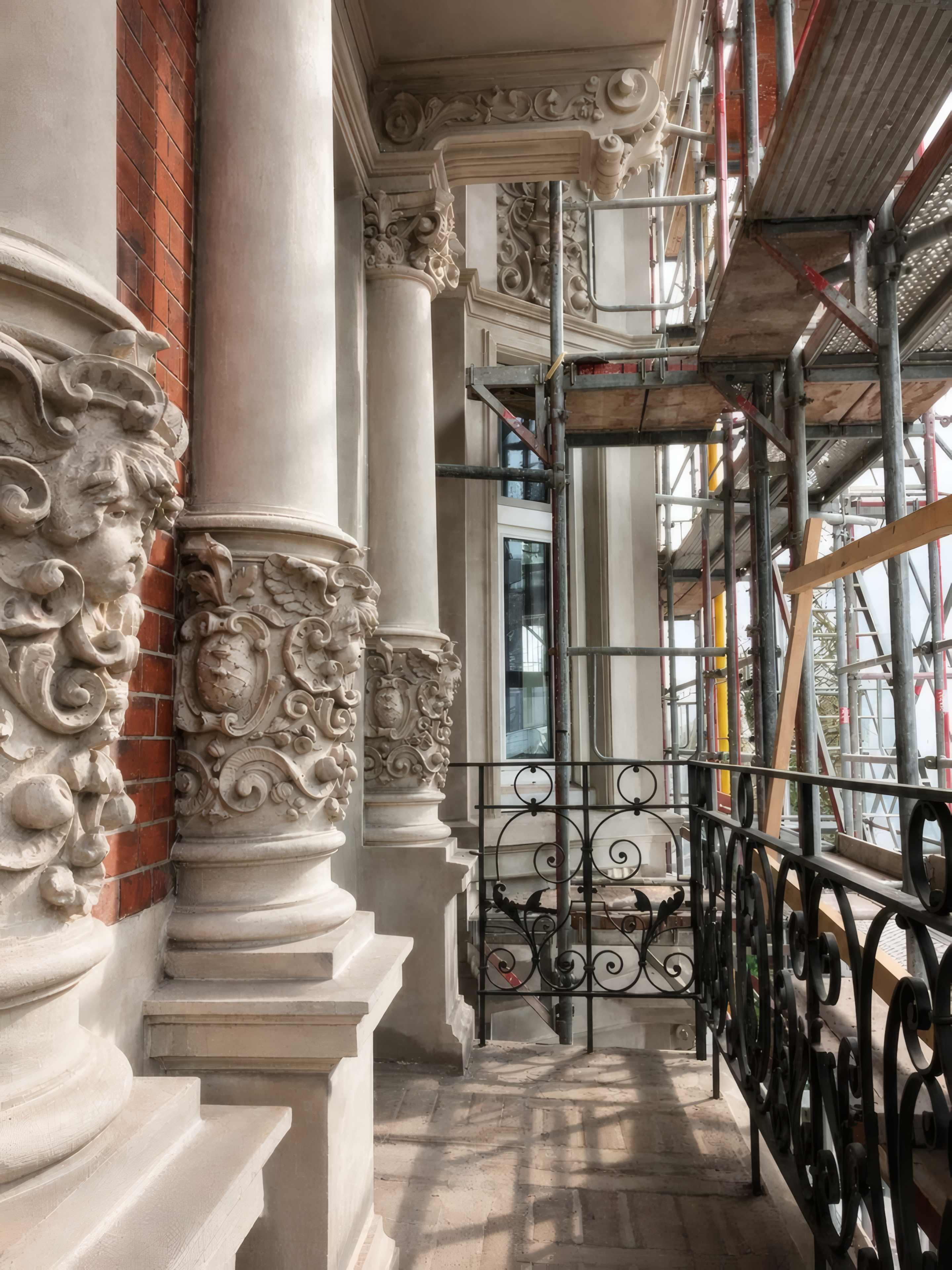 Stucco facade of a Hamburg period building under scaffolding during renovation